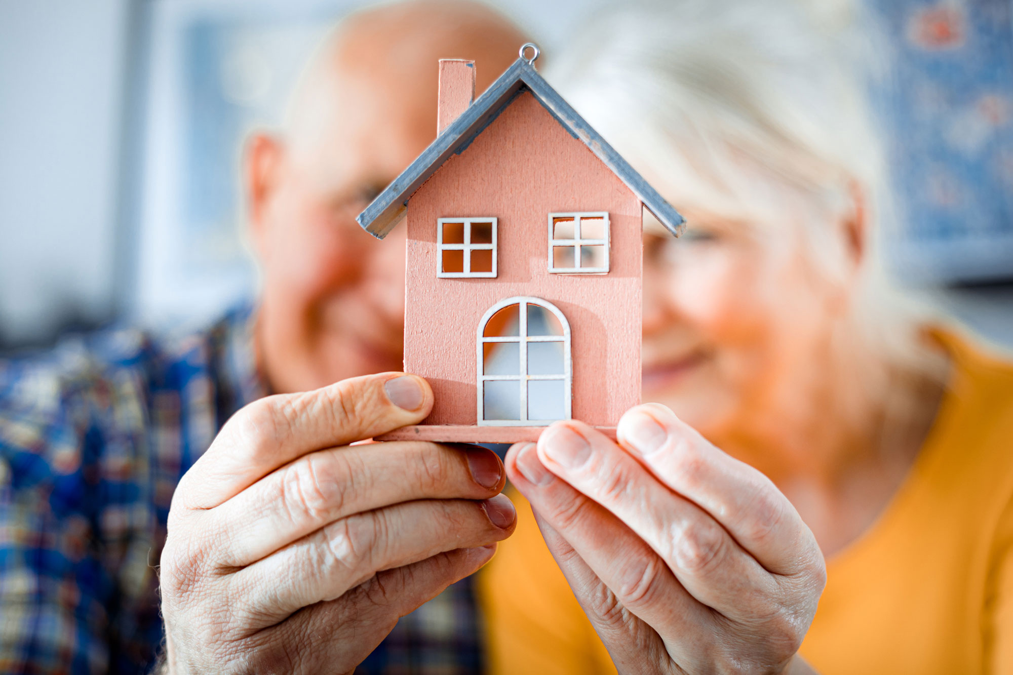 happy seniors with home in hands | affordable housing resources | Mill Valley Affordable Housing | Community Housing Foundation Mill Valley